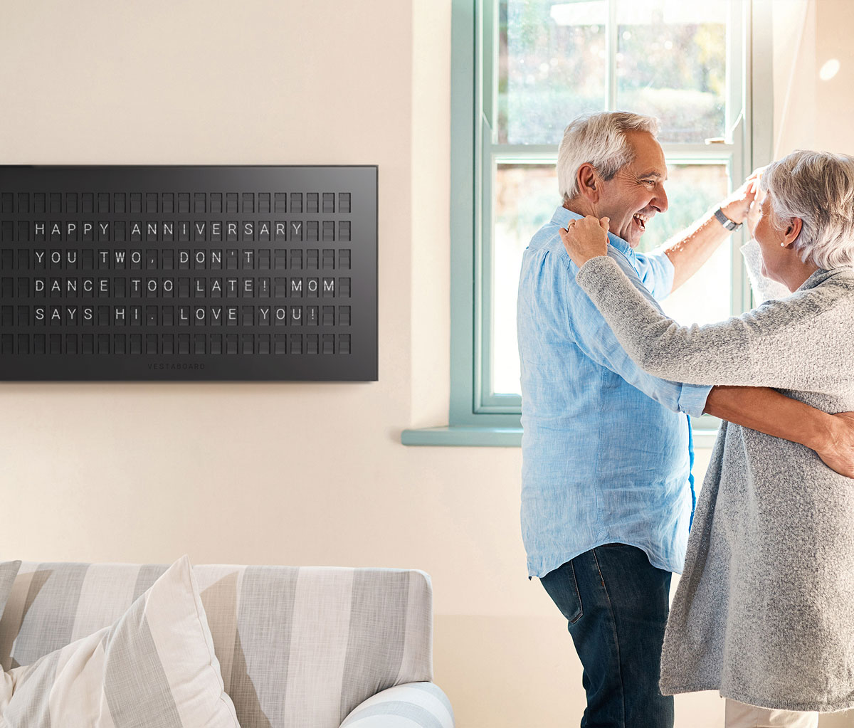 Couple enjoying their Vestaboard at home