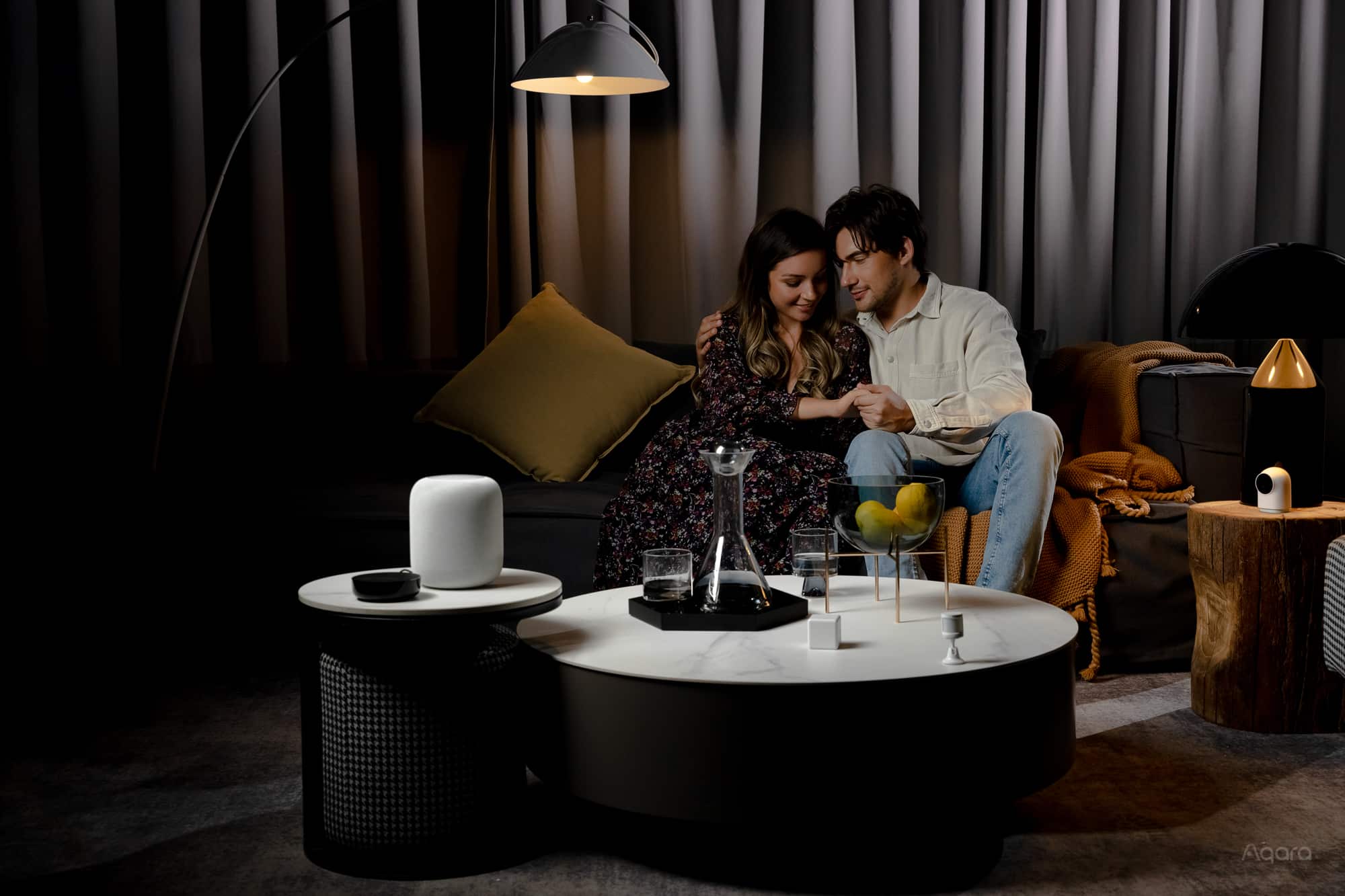 Aqara Hub M2 in a living-room scene alongside other smart devices
