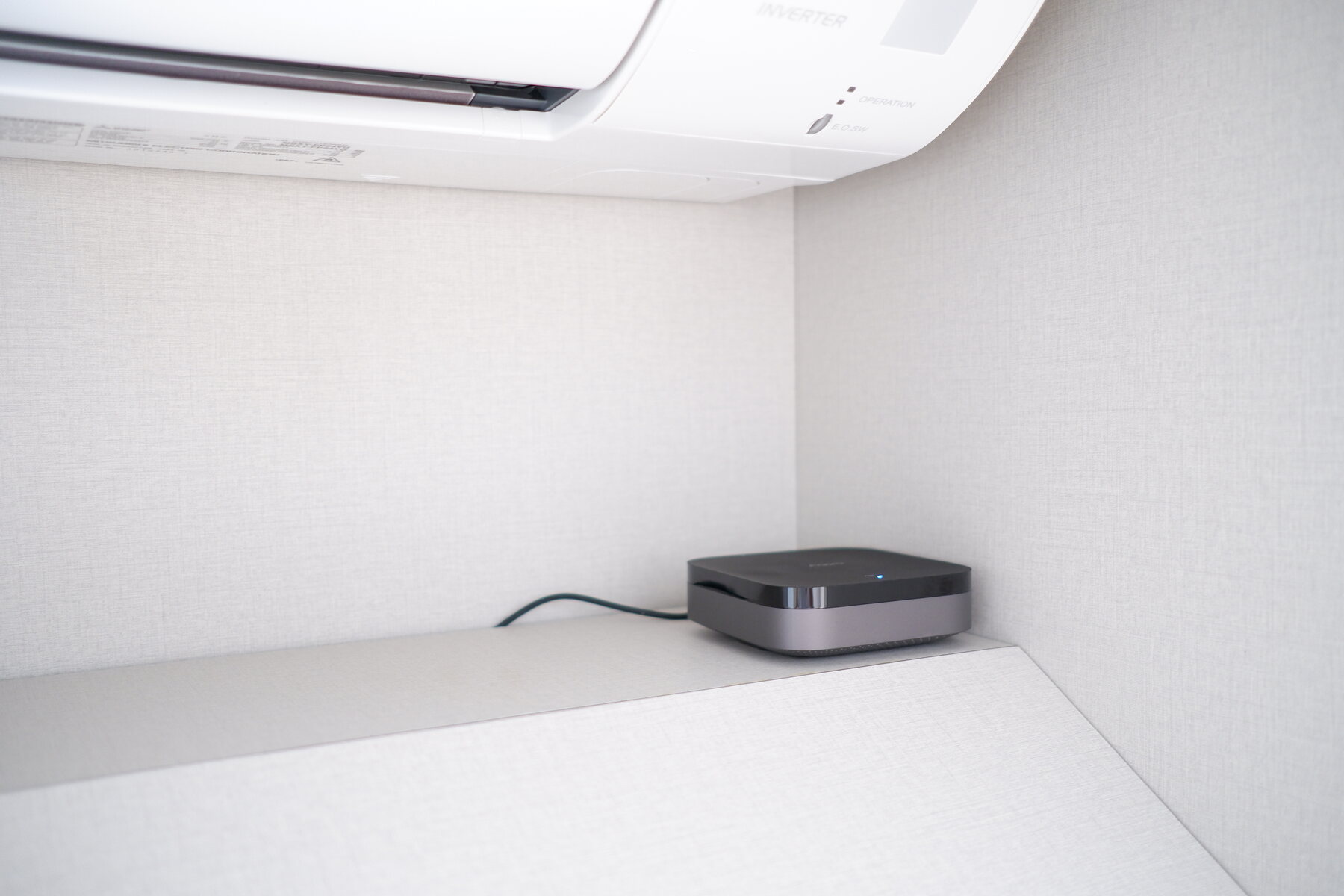 Aqara M3 hub placed below an air-conditioner in a HomeSmart project