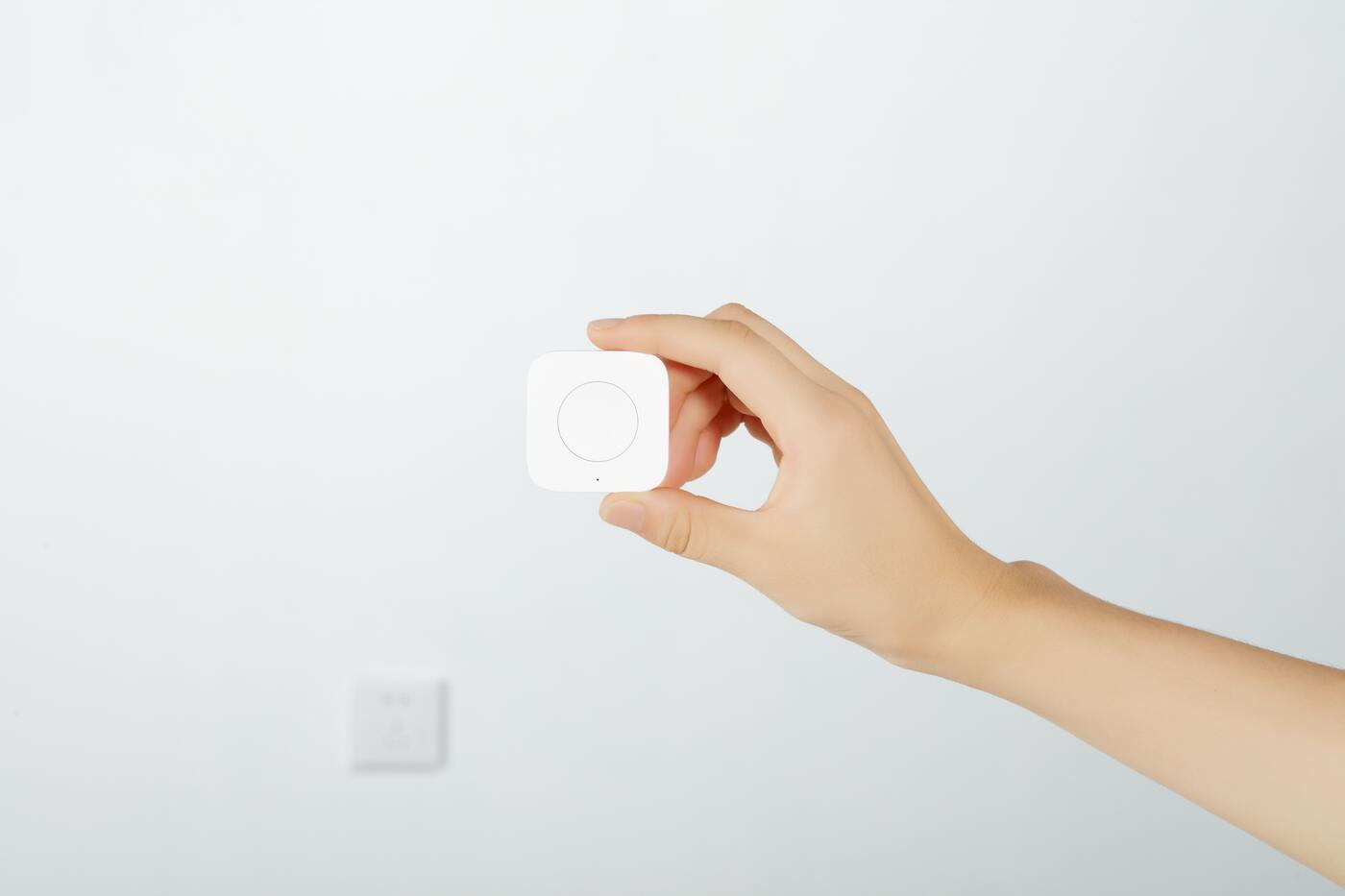 Aqara Wireless Mini Switch held in a hand