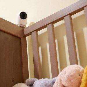 Indoor camera positioned above a baby cot