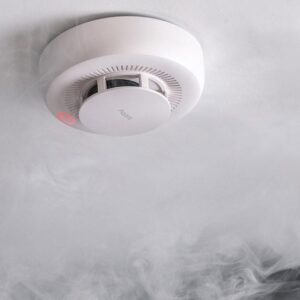 Smoke detector sounding in a smoky kitchen