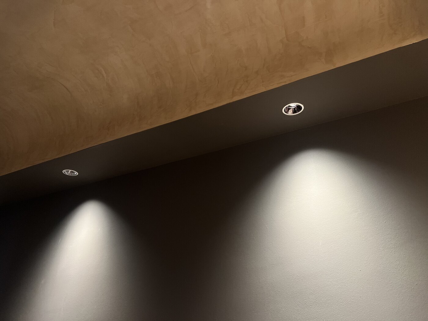Recessed spotlights creating wall wash lighting in a HomeSmart project
