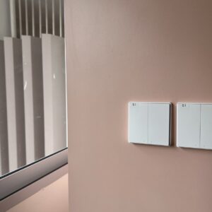Two Aqara smart wall switches installed beside a window
