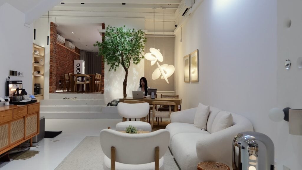 The HomeSmart showroom living room at Keong Saik Road, with someone working at the desk