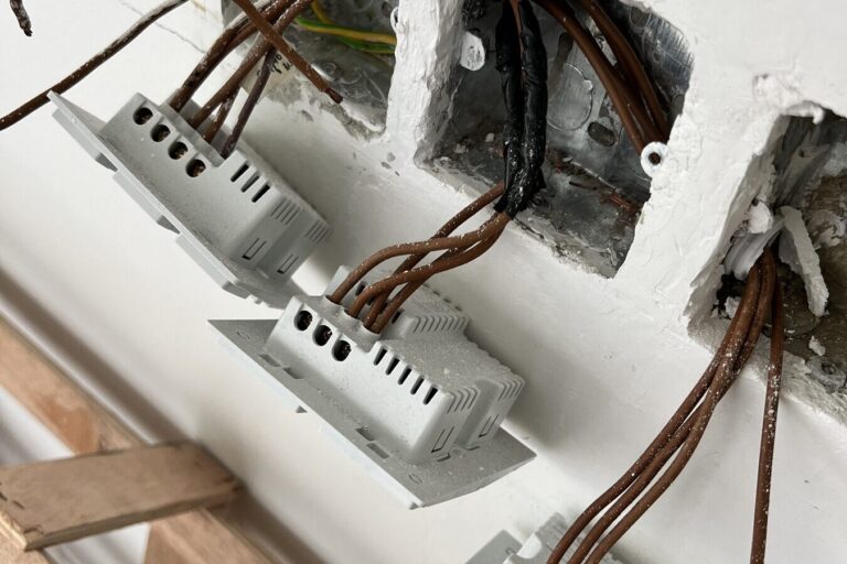 Smart switch mechanisms connected to their wiring before being fitted into the wall boxes